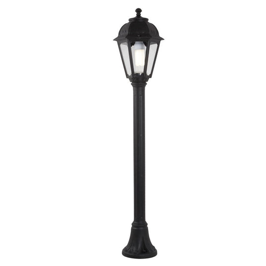 Black outdoor bollard light with classic lantern design and clear vertical panels.