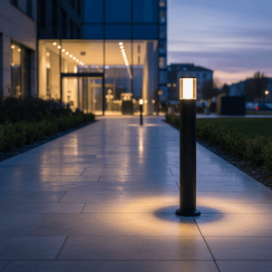 Modern LED bollard light illuminating a pathway at dusk, showcasing sleek design and warm glow.