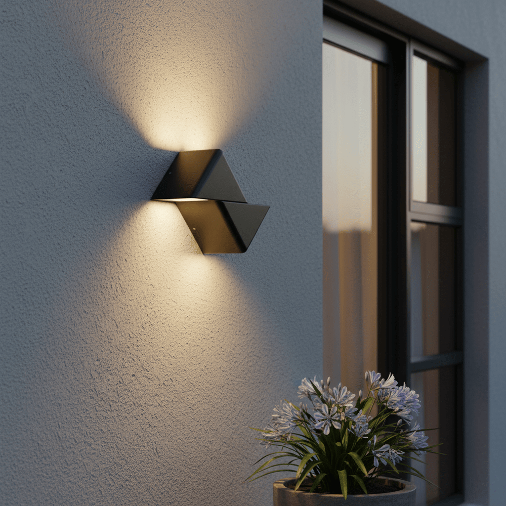 Black outdoor LED wall light mounted on a textured wall, illuminating a nearby potted plant.