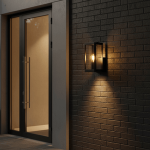 Bhok Ali Square Outdoor Wall Light mounted on a textured brick wall beside a glass door, illuminating the entrance.