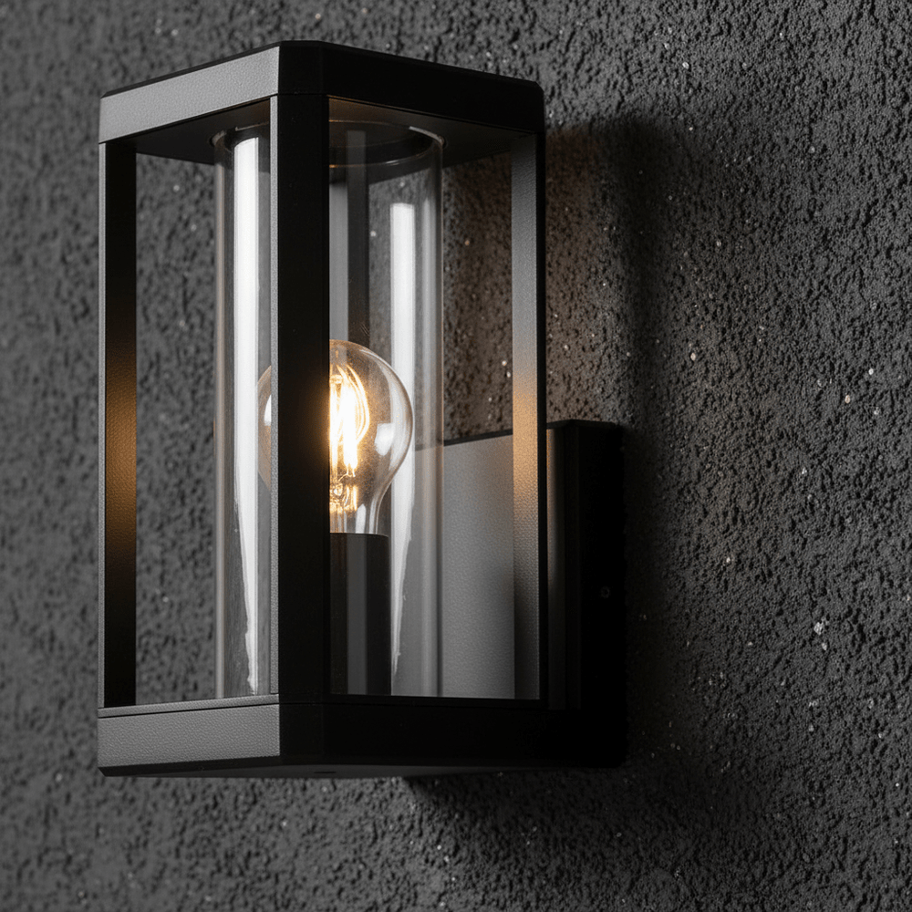 Close-up of the Bhok Ali Square Outdoor Wall Light showcasing its black die-cast aluminum frame and clear glass.