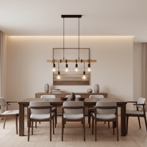 A wooden dining table with gray upholstered chairs, illuminated by a black and wood pendant light above.