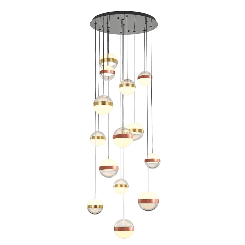 A cluster of spherical pendant lights in varying sizes, featuring gold, silver, and white finishes, suspended from a black ceiling mount.