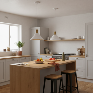 Two white iron pendant lights hang over a wooden kitchen island, illuminating a bowl of fruits.