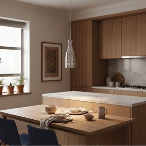 Aluminium pendant light hanging over a wooden dining table set with dishes in a modern kitchen.