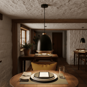 Black iron pendant light hanging over a dining table set with plates and a tablet, in a cozy interior.