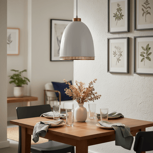 White iron pendant light hanging above a wooden dining table set with plates and glasses, surrounded by decor.