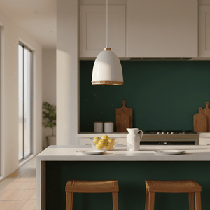White iron pendant light hanging above a kitchen island with lemons and plates on a marble countertop.