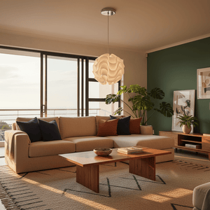 Stylish white wavy pendant light hanging above a modern living room with a beige sofa and wooden coffee table.