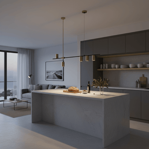 Black and gold pendant light above a modern kitchen island, illuminating a loaf of bread and decor.