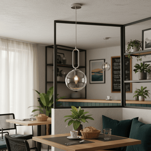 Satin chrome pendant light with clear glass shade hanging above a cozy dining table setup.