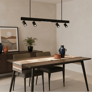Black LED pendant light above a modern dining table with decorative vases and a framed artwork.