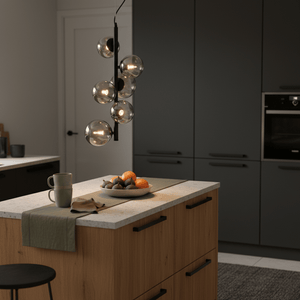 Nebula Metal Pendant with smoke glass shades hanging over a kitchen island with fruit and a mug.