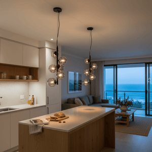 Nebula Metal Pendant with smoke glass shades hanging over a kitchen island, creating a warm ambiance.