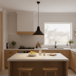 Black pendant light with gold interior hangs over kitchen island
