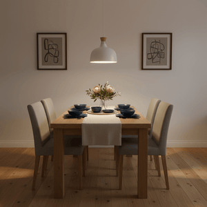 Stylish dining setup featuring a white metal and wood pendant light above a wooden table with floral centerpiece.