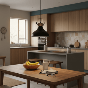 Black metal pendant light hanging over a wooden dining table with a bowl of bananas and a jug.