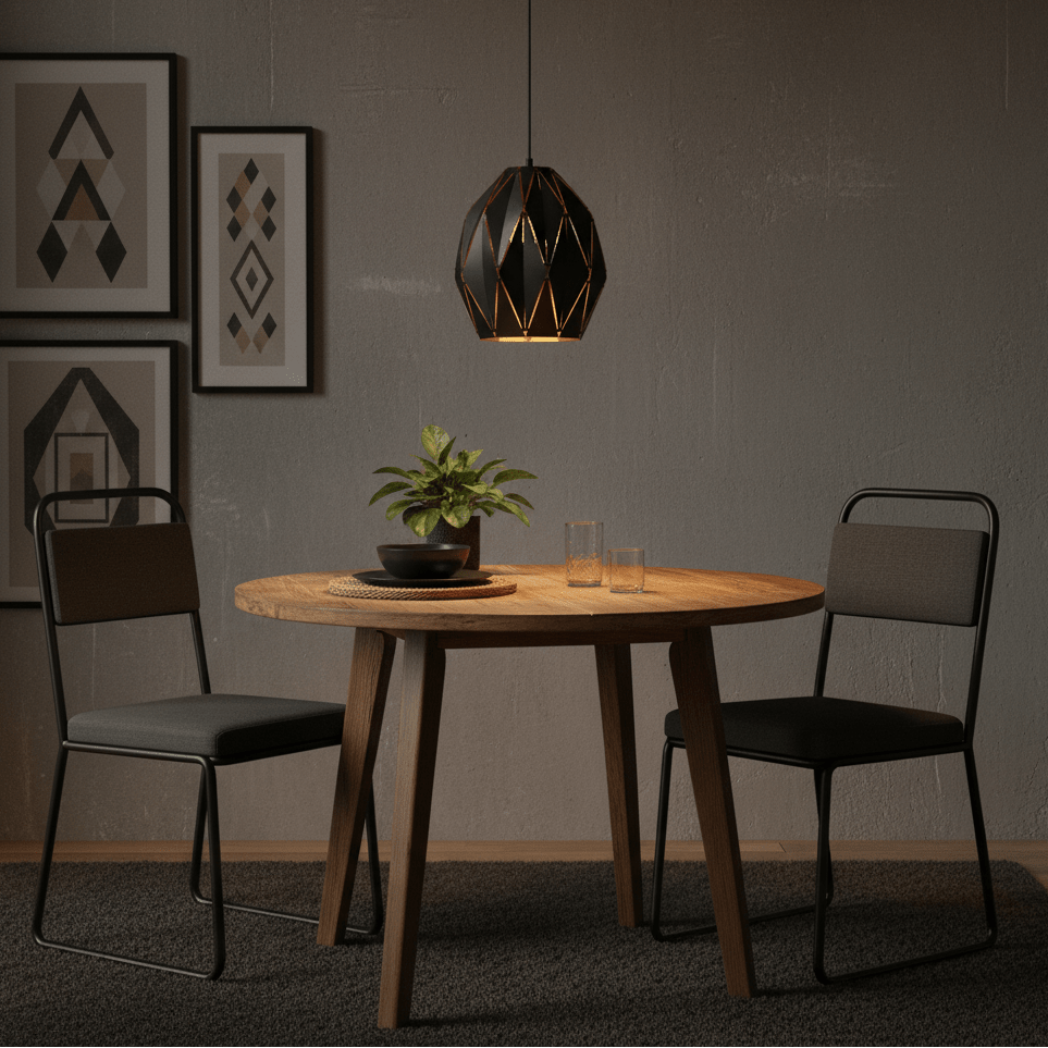 Black metal pendant light hanging above a wooden dining table with two chairs and decorative plant.
