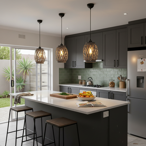 Three Metal and Rattan Pendant Lights hanging above a kitchen island with a fruit bowl and cutting board.
