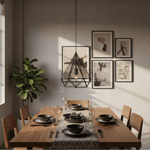 Geometric metal pendant light hanging above a dining table set with plates and glasses, surrounded by artwork.