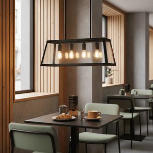 Black 4-light pendant hanging above a dining table with coffee, croissant, and glass of water.