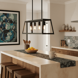 Black 4-light pendant hanging above a kitchen island with a bowl of oranges and decorative items.