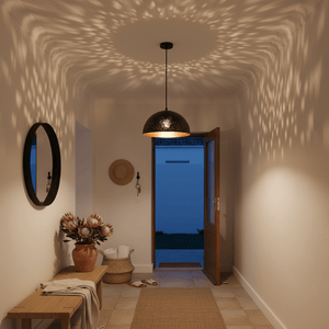 Black metal pendant light casting starry patterns on the wall in a cozy entryway.