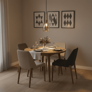 Stylish dining area featuring a gold and amber glass pendant light above a wooden table set for dinner.