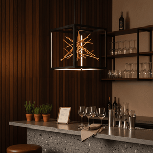 Black and gold LED pendant light hanging above a modern bar counter with plants and glassware.