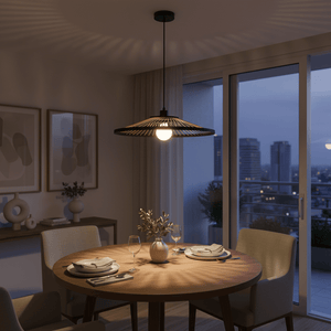 Hara Bamboo & Metal Pendant Light hanging over a dining table, casting warm light and shadows in a modern setting.