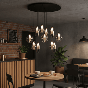 Hailo 11 Light Smoke Glass Pendant hanging over a wooden table with coffee cups and pastries in a modern cafe setting.