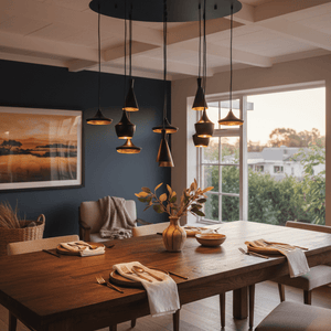Elegant dining setup featuring the Skyfall 11 Light Black & Gold LED Pendant above a wooden table, with stylish decor.