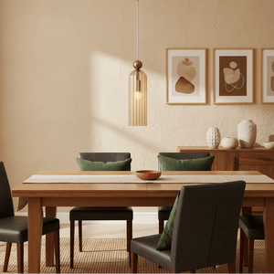 Antic Gold & Amber Pendant Light hanging above a wooden dining table with green cushions and decorative vases.