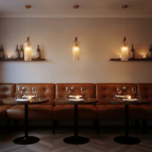Warmly lit dining area featuring Antic Gold & Amber Pendant Lights above wooden tables with cozy seating.