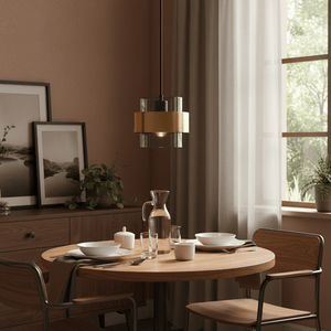Astrid Gold Pendant Light hanging above a dining table set with dishes and a pitcher, in a cozy interior.
