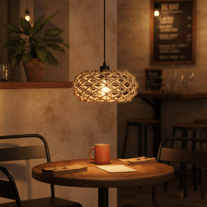 Colenso Rope Pendant Light hanging above a wooden table with a coffee mug and menus, creating a warm ambiance.