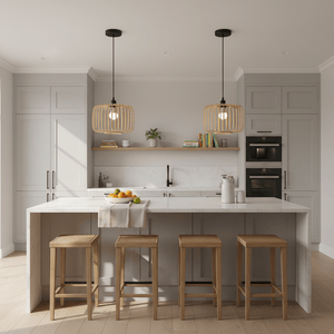 Stylish kitchen featuring Haiku Bamboo & Metal Pendant Lights above a marble island with wooden stools.