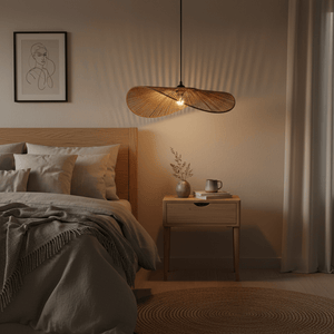 Aporia Natural Rattan Pendant light hanging above a cozy bedroom setting with a wooden bed and nightstand.