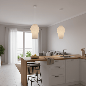 Two Bluebell pendant lights hang over a wooden kitchen island, illuminating a modern, airy space.