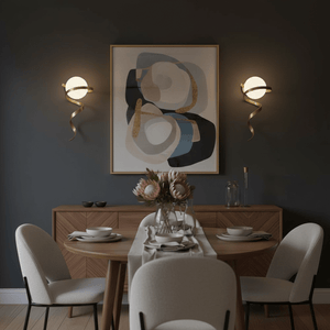 Gold infinity wall light illuminating a dining area with a modern table and floral centerpiece.