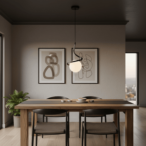Black Infinity Pendant Light hanging above a wooden dining table with decorative plates and a plant in a modern interior.