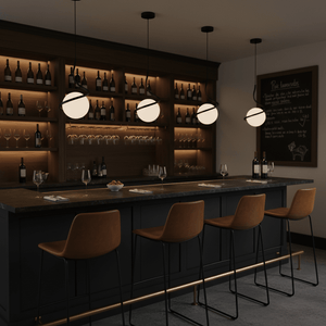 Three Black Infinity Pendant Lights hang above a stylish bar with a dark countertop and wooden shelves filled with wine
