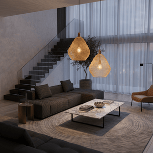 Stylish living room featuring two gold mesh pendant lights above a marble coffee table, creating a warm ambiance.