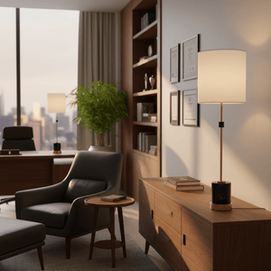 Stylish black and gold marble table lamp on a wooden console in a modern office setting.