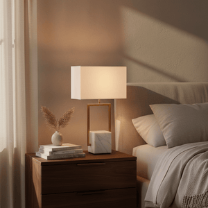 Verdi Gold & Marble Table Lamp on a bedside table with books and a decorative vase.