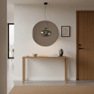 Modern green-tinted glass pendant light hanging above a wooden console table in a stylish entryway.