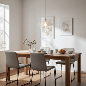 Stylish dining area featuring a white pendant light above a wooden table set with dishes and decor.