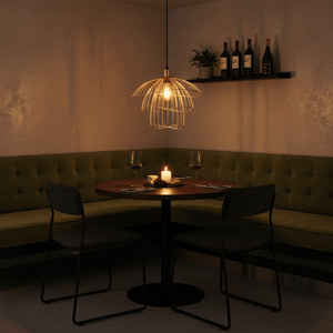 Stylish Sensu Trio Gold Pendant Light hanging above a cozy dining table with wine glasses and a candle.