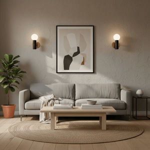 Stylish indoor scene featuring the Ollie Black Marble Wall Light beside a modern sofa and artwork.