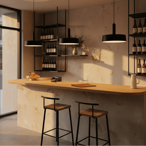 Sombre Black Pendant lights hanging above a wooden bar with bottles and fruit bowl in a modern setting.